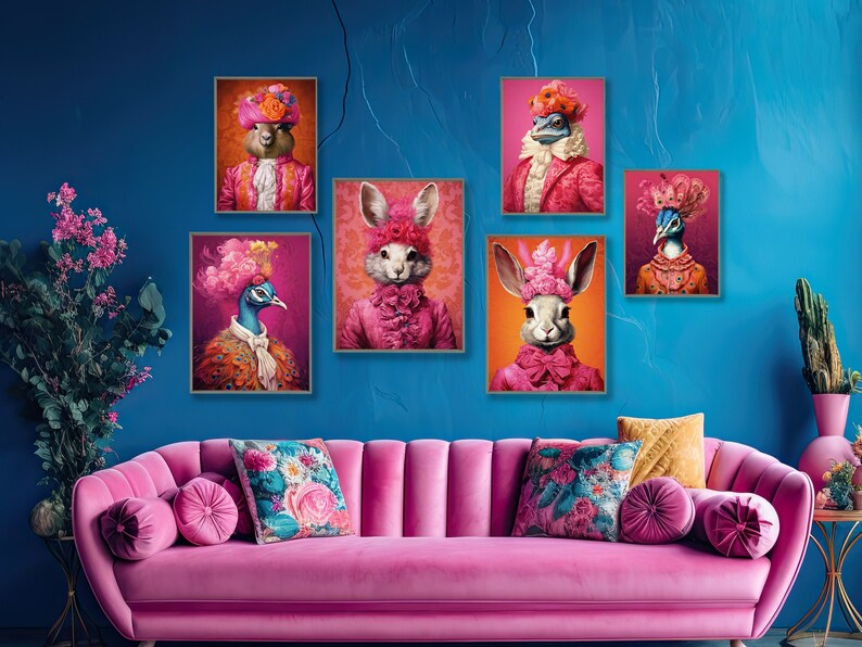 May include: Five framed prints of animals dressed in pink and white clothing with floral accents. The prints are hung on a blue wall above a pink velvet sofa with floral patterned pillows.
