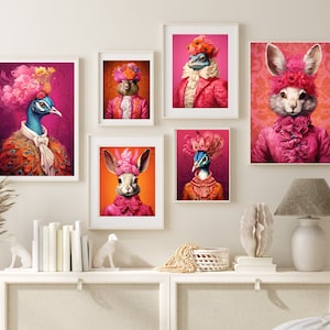 May include: Five framed prints of animals wearing elaborate pink and orange costumes and hats. The animals are a peacock, a rabbit, a squirrel, a lizard, and a bird. The prints are displayed on a white wall above a white dresser.