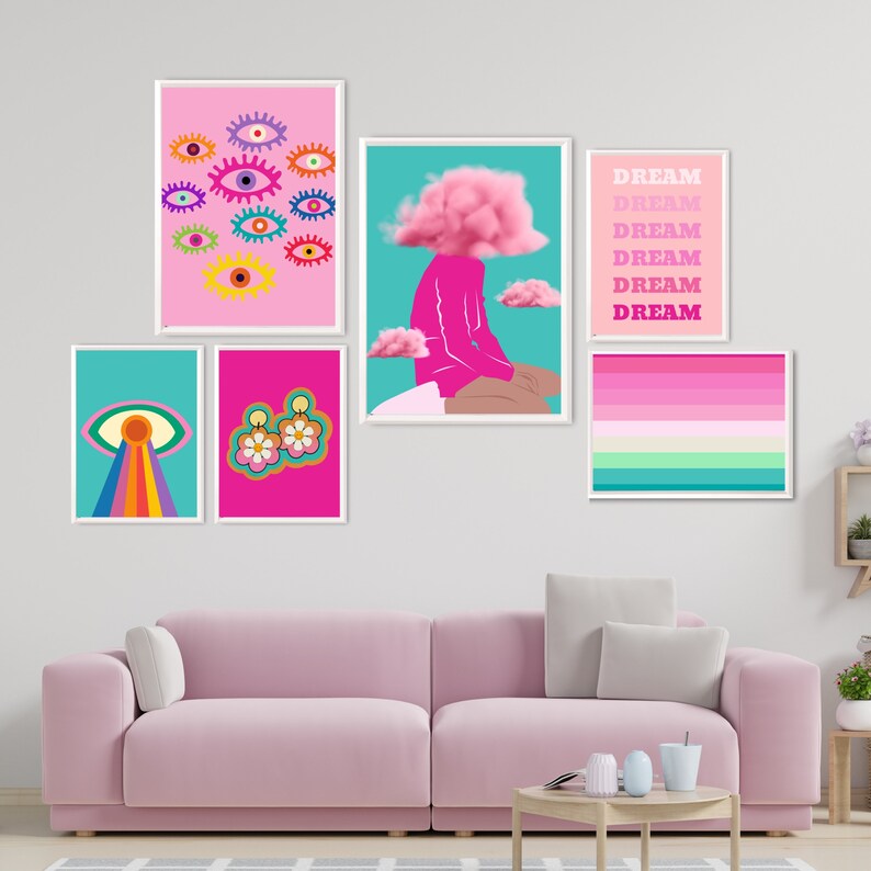 May include: A collection of framed art prints with a vibrant, colorful aesthetic. The prints feature eye motifs, floral designs, and abstract illustrations. One print displays the word "DREAM" repeated vertically. The color palette includes pink, teal, and rainbow hues.