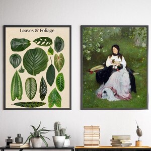 May include: Two framed prints, one with a botanical illustration of various leaves and foliage labeled "Leaves & Foliage", and the other with a painting of a woman sitting in a garden with a dog.