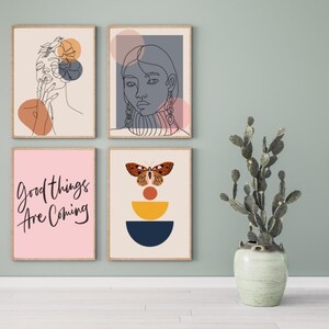 May include: Four framed prints with abstract designs. The top left print features a line drawing of a woman with a flower in her hair. The top right print features a line drawing of a woman with a geometric design behind her. The bottom left print features the text "Good things are coming". The bottom right print features a butterfly with geometric shapes behind it.