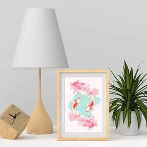 May include: A framed print of two koi fish swimming in a circle, surrounded by pink cherry blossoms and watercolor splashes. The background is a light blue color.