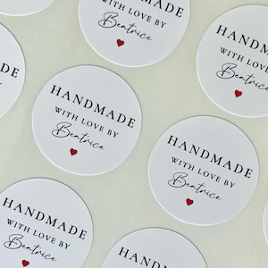 May include: A collection of circular white stickers featuring the black text HANDMADE WITH LOVE BY Beatrice and a small red heart icon. The stickers are arranged in a repeating pattern, each displaying the same design and typography.