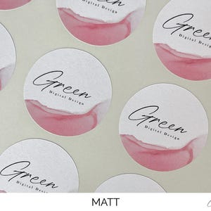 May include: A collection of circular matte stickers featuring a white background with a soft pink watercolor wash at the bottom. Each sticker displays the black text Green Digital Design in a combination of script and sans-serif typography.