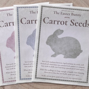 May include: Three seed packets with a bunny silhouette and the text "The Easter Bunny Carrot Seeds" on the front. The packets are in pink, blue, and gray.
