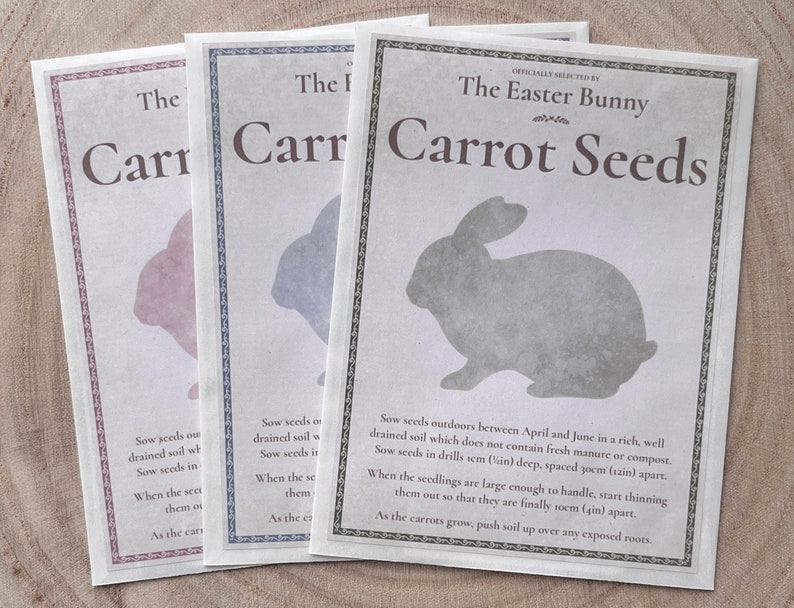 May include: Three seed packets with a bunny silhouette and the text "The Easter Bunny Carrot Seeds" on the front. The packets are in pink, blue, and gray.