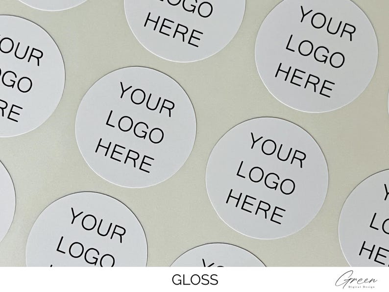 May include: A collection of circular white stickers featuring the black text YOUR LOGO HERE printed in the center. The stickers have a smooth, reflective gloss finish and are arranged in a repeating pattern across the frame for branding purposes.