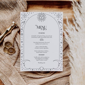 May include: A black and white printable wedding menu with a celestial theme. The menu includes a starter, main course, dessert, and wedding cake. The text reads: "MENU, STARTER, Artichoke and spinach dip, tuscan bread, Fried house made mozzarella sticks with sauce, MAIN, Succulent beef prime rib served medium rare, jasmin rice, Twice cooked shoulder of lamb, roasted vegetables, House made honey chicken, mixed salad variation, DESSERT, Vanilla cake with strawberries and whipped cream filling, Apple & plum strudel, Wedding cake".