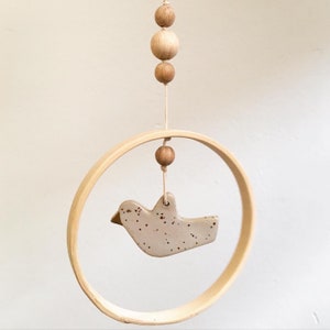 Mobile with ceramic bird in a wooden ring and wooden beads / handmade / hanging decoration / decorative pendant / Boho / Scandi