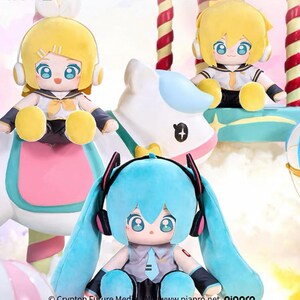 May include: Three plush dolls with large eyes and headphones. Two dolls have yellow hair and one has blue hair. The dolls are wearing sailor-style outfits. The dolls are sitting on a carousel-like structure with a white horse.