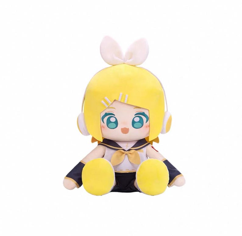 May include: A plush doll featuring a yellow-haired character with blue eyes, wearing a sailor-style outfit with a bow. The doll has white bunny ears and headphones. The doll is sitting with its legs extended.