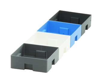 May include: Four empty plastic storage containers stacked on top of each other. The containers are grey, white, and blue.