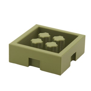 May include: A green plastic storage box with four compartments. The box is square shaped and made from a textured material.