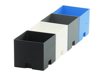 May include: Four plastic storage boxes in a row, from left to right: black, white, grey, and blue.