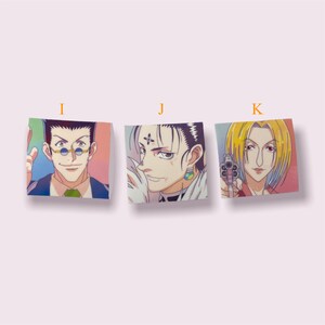 May include: Three square stickers featuring anime characters. The first sticker features a man with black hair and glasses wearing a suit. The second sticker features a man with black hair and a cross on his forehead wearing a white collar. The third sticker features a woman with blonde hair and a gun in her hand wearing a red shirt.