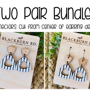 May include: Two pairs of wooden earrings with a black and white striped design. The earrings are shaped like a triangle with a smaller triangle cut out of the center. The earrings are on a wooden display card with the text "BLACKBURN RD. DESIGNS" printed on it.