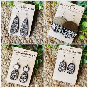 Puede incluir: Cuatro pares de pendientes de madera con patrones geométricos. Los pendientes se muestran en tarjetas con el texto "Blackburn Rd. Designs".