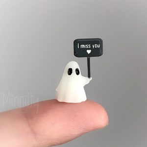 Miniature ghost with glowing text sign