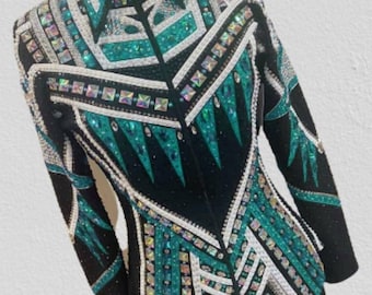 May include: Black show jacket with teal and white geometric designs and rhinestones. The jacket has a zipper closure and a collar. The text "Alina By Alina" is visible at the top of the image.