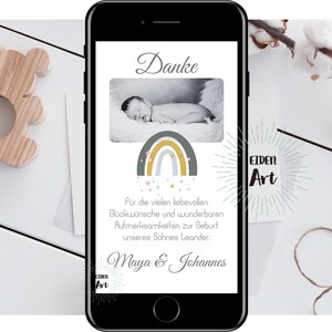 May include: A smartphone screen displaying a thank you card with a rainbow and stars design. The card says "Danke" and "For the many loving wishes and wonderful attentions for the birth of our son Leander. Maya & Johannes." The card also has a logo that says "EIDEN Art".