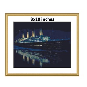 May include: A framed 8x10 inch print of a black and white image of the Titanic ship at night. The ship is illuminated by lights and is reflected in the water.