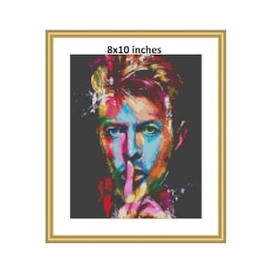 May include: A colorful portrait of David Bowie with his finger to his lips, in a 8x10 inch frame.