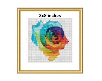 May include: A rainbow rose cross-stitch pattern in an 8x8 inch frame. The rose is a vibrant mix of red, orange, yellow, green, blue, and purple.
