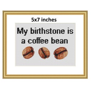 Puede incluir: Arte de punto de cruz enmarcado con el texto "My birthstone is a coffee bean" sobre tres imágenes de granos de café. El marco es dorado y la obra de arte mide 12,7 x 17,8 cm.