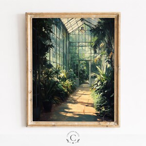 May include: A framed wall art print depicting a sunlit greenhouse interior with a central walkway flanked by lush green tropical plants and large glass windows. The scene features a warm, golden light filtering through the glass structure.