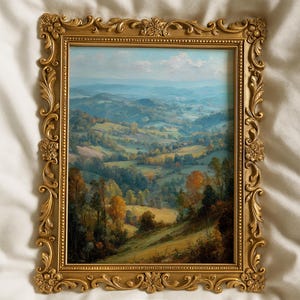 May include: A framed landscape painting with a gold ornate frame. The artwork depicts rolling hills and valleys in shades of green, yellow, and brown, under a blue sky. The frame has intricate floral and scrollwork details. The bottom right corner has the text "Carlton Prints".