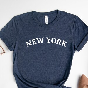 New York City souvenir shirts for sale in a gift shop Manhattan New York  City USA. - SuperStock
