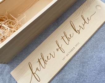 May include: Wooden box with a lid, the lid is engraved with the text "father of the bride" and the date "14th October 2022".