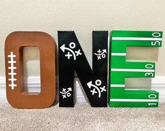 1st Year Down Football Painted Birthday Letters O-N-E, Brown, Green, Black, Football Laces, Plays, Football Field