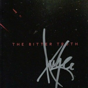 May include: Black and white signature on a black background with the text "THE BITTER TRUTH" in red.