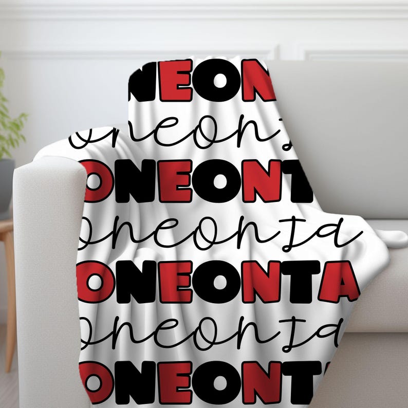 May include: White fleece throw blanket with the words "NEONTA" repeated in black and red lettering.