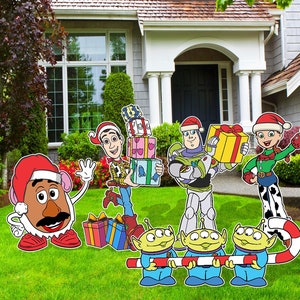 May include: A Christmas-themed yard decoration set featuring characters from the Toy Story franchise. The set includes Woody, Buzz Lightyear, Jessie, Mr. Potato Head, and three aliens. The characters are holding presents and candy canes.
