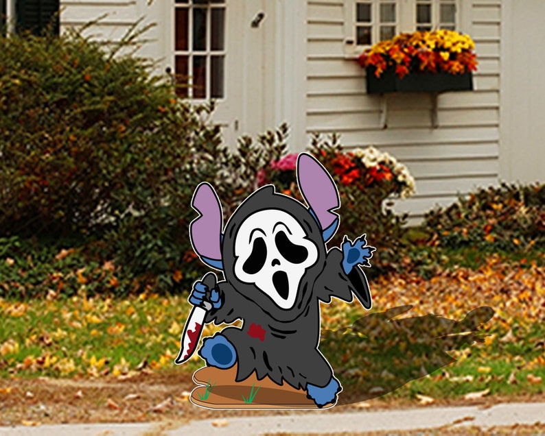 May include: A blue and black cartoon character with a white ghost mask holding a bloody knife. The character is standing on a brown surface in front of a house with a white siding and green bushes.