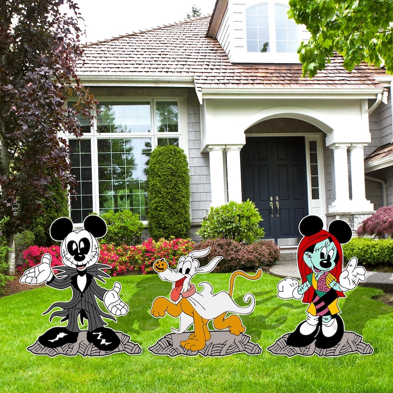 May include: A set of four Halloween yard decorations featuring characters from Disney's Nightmare Before Christmas and Mickey Mouse. The characters are Jack Skellington, Sally, Zero the Ghost Dog, and Mickey Mouse dressed as Jack Skellington. The decorations are made of wood and are painted in black, white, orange, green, and red.