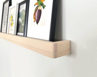 Handmade wooden wall-mounted shelf for photos, paintings, and frames.