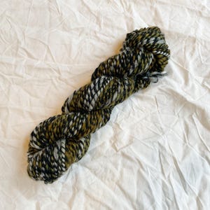 Handspun Randomly-Striped Newspaper Green Marled Yarn Using Merino Wool and Recycled Materials