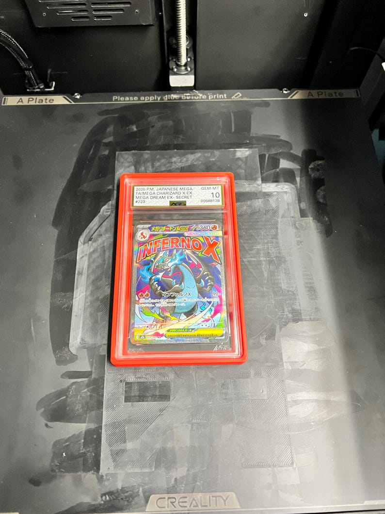 May include: A graded Japanese Mega Charizard X EX Secret card in a red holder. The card features a colorful illustration of a dragon-like creature with the text "INFERNO X". The card is graded GEM-MT 10.