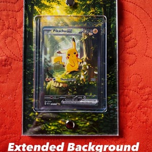 May include: A clear acrylic frame with a Pikachu EX trading card inside. The card features a yellow Pikachu character in a forest setting. The frame has a forest background and is held together with two silver fasteners. Text at the top reads "Ascended Heroes Pikachu EX".