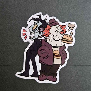 May include: A sticker featuring two cartoon characters. The character on the left is a tall, thin, black-clad figure with a pale face and a wide, toothy grin. The character on the right is a short, round, red-haired figure wearing a purple jacket, a white shirt, and a brown hat. The character on the right is holding a hamburger.
