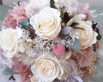 May include: A bouquet of white roses and dried flowers in shades of pink and beige. The bouquet is arranged in a circular shape and features a variety of textures, including feathers and greenery.