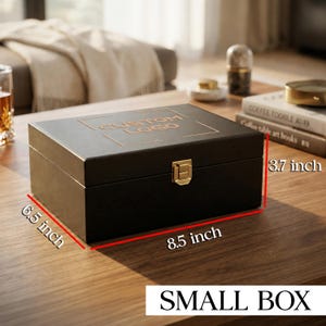 May include: A rectangular black wooden box with a gold-colored metal latch and the text CUSTOM LOGO engraved on the lid. The box measures 8.5 inches in length, 6.5 inches in width, and 3.7 inches in height as indicated by the red dimension lines.