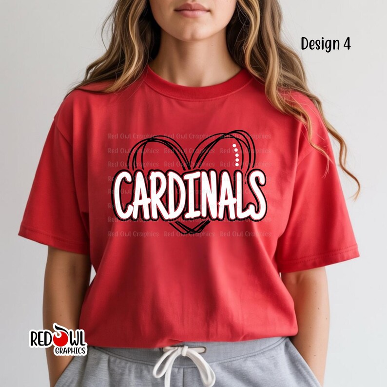 May include: Red t-shirt with the word "CARDINALS" in white, outlined in black, inside a black heart design. The shirt also features the text "Design 4" and the "RED OWL GRAPHICS" logo.