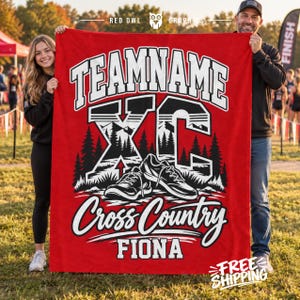 May include: A red fleece blanket featuring the text TEAMNAME, XC, Cross Country, and FIONA in white and black. The graphic includes a pair of running shoes, a forest silhouette, and mountain peaks. The design is centered on the fabric.
