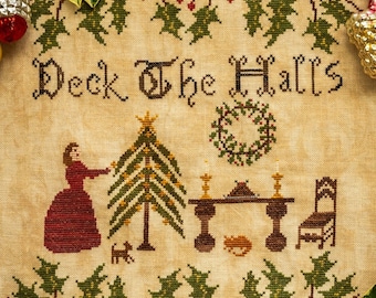 May include: A cross-stitch sampler with the text "Deck the Halls" and a scene of a woman decorating a Christmas tree. The sampler is framed by a border of holly leaves and red berries.