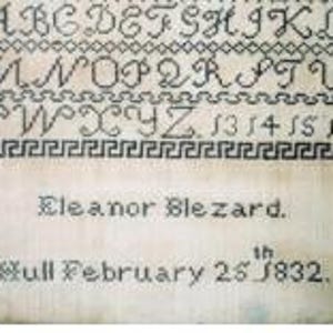 May include: A sampler featuring black cross-stitched letters of the alphabet from A to Z, numbers 13 through 16, and a geometric border. The text reads Eleanor Blezard, Hull February 25th 1832, stitched in a dark thread on a light-coloured fabric background.