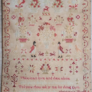 May include: Antique sampler with a cream-colored background, featuring red and cream cross-stitch embroidery. The design includes floral motifs, birds, deer, and figures. Text at the bottom reads "Thee ican love and thee alone" and the year 1855.